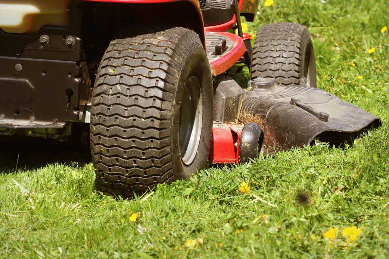 close up of ride on mower cutting a lawn